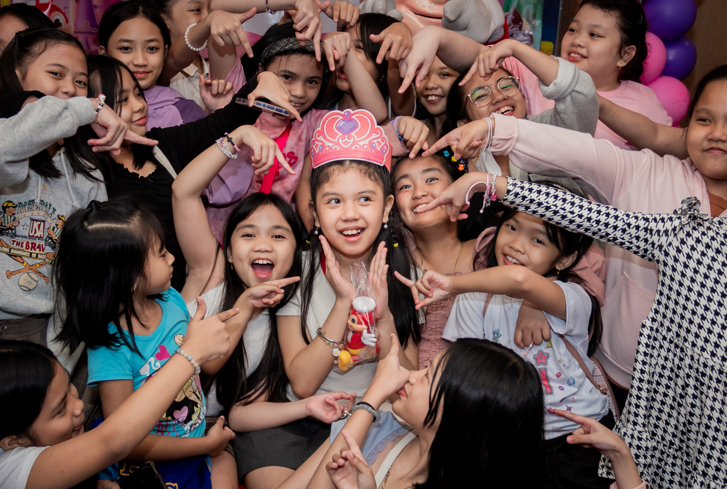 Happy multicultural family of five playing in autumn park with colorful leaves and warm sunlight filtering through trees