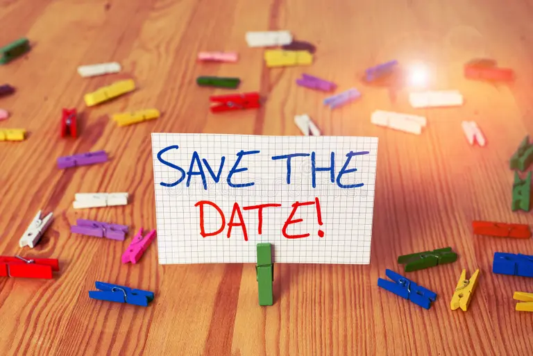 Breathtaking landscape with a model standing on a cliff edge at sunset overlooking mountains and lake with dramatic lighting